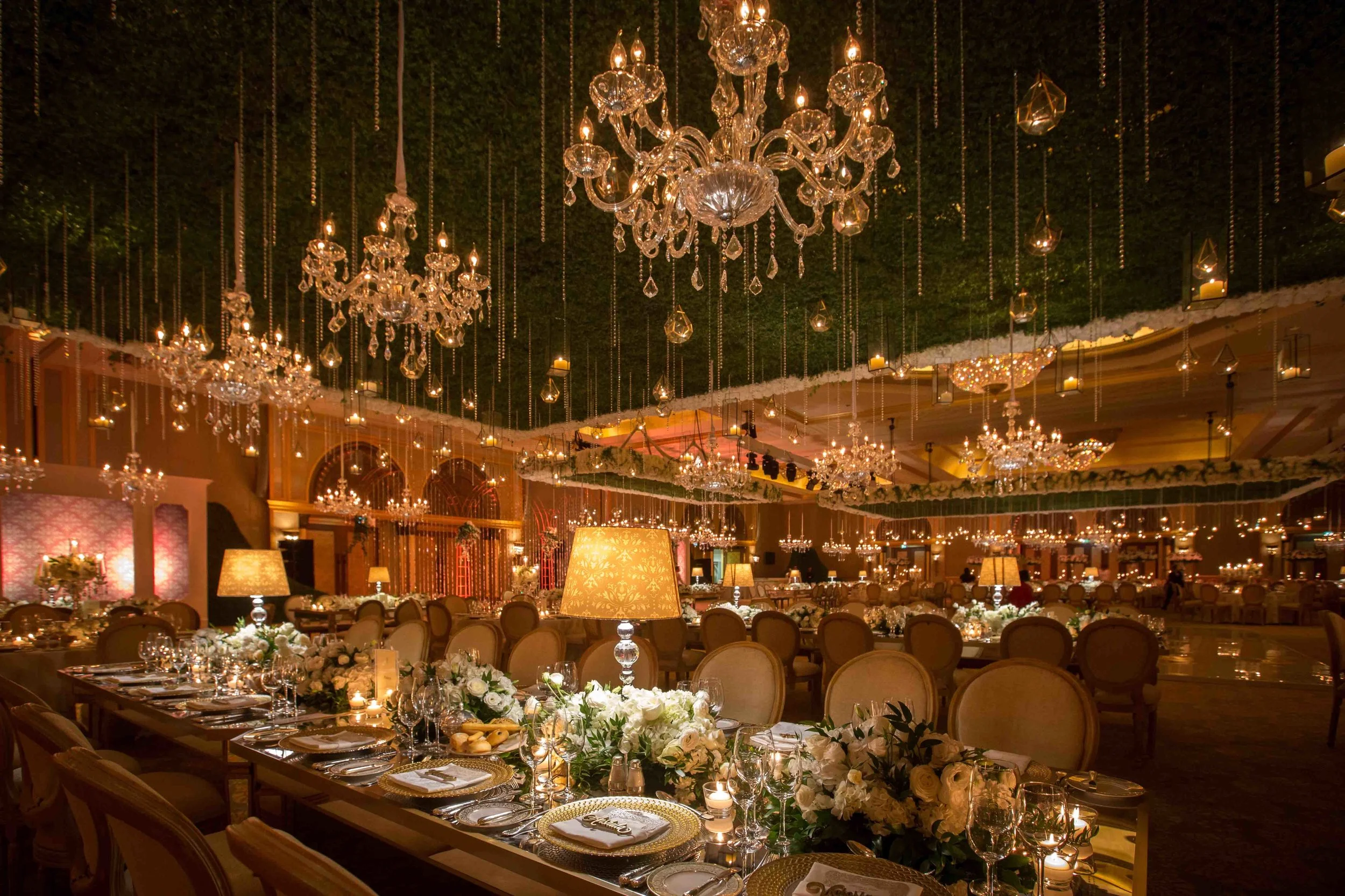 Ballroom wedding beneath layers of chandeliers