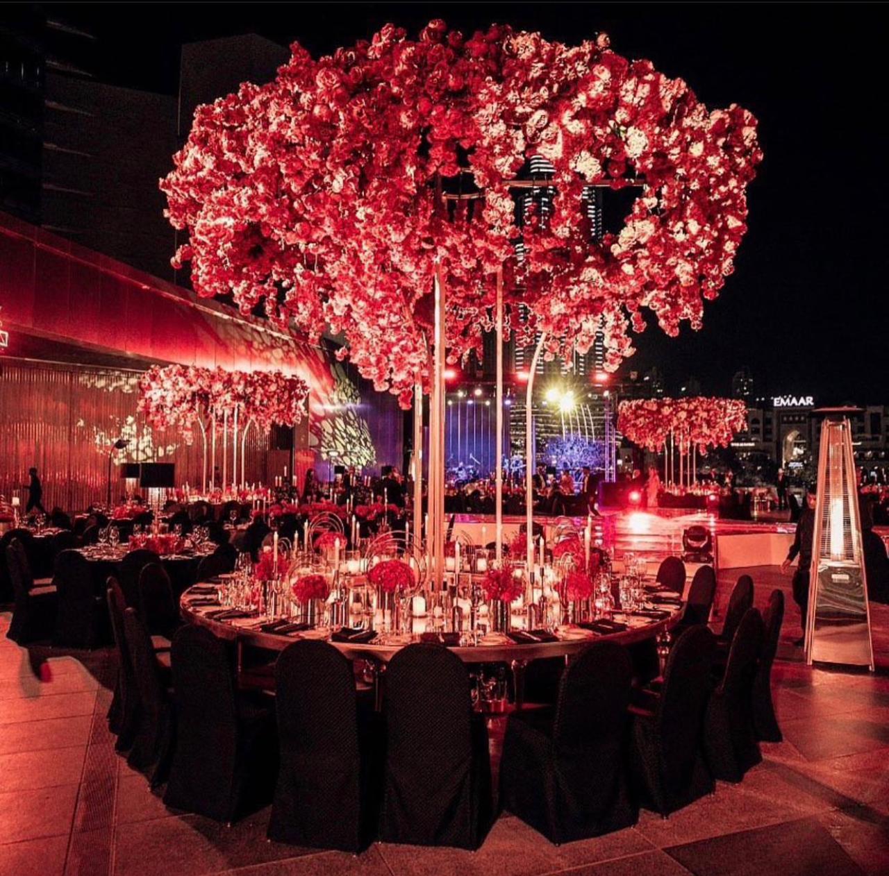 Gala dinner beneath a suspended canopy of red florals